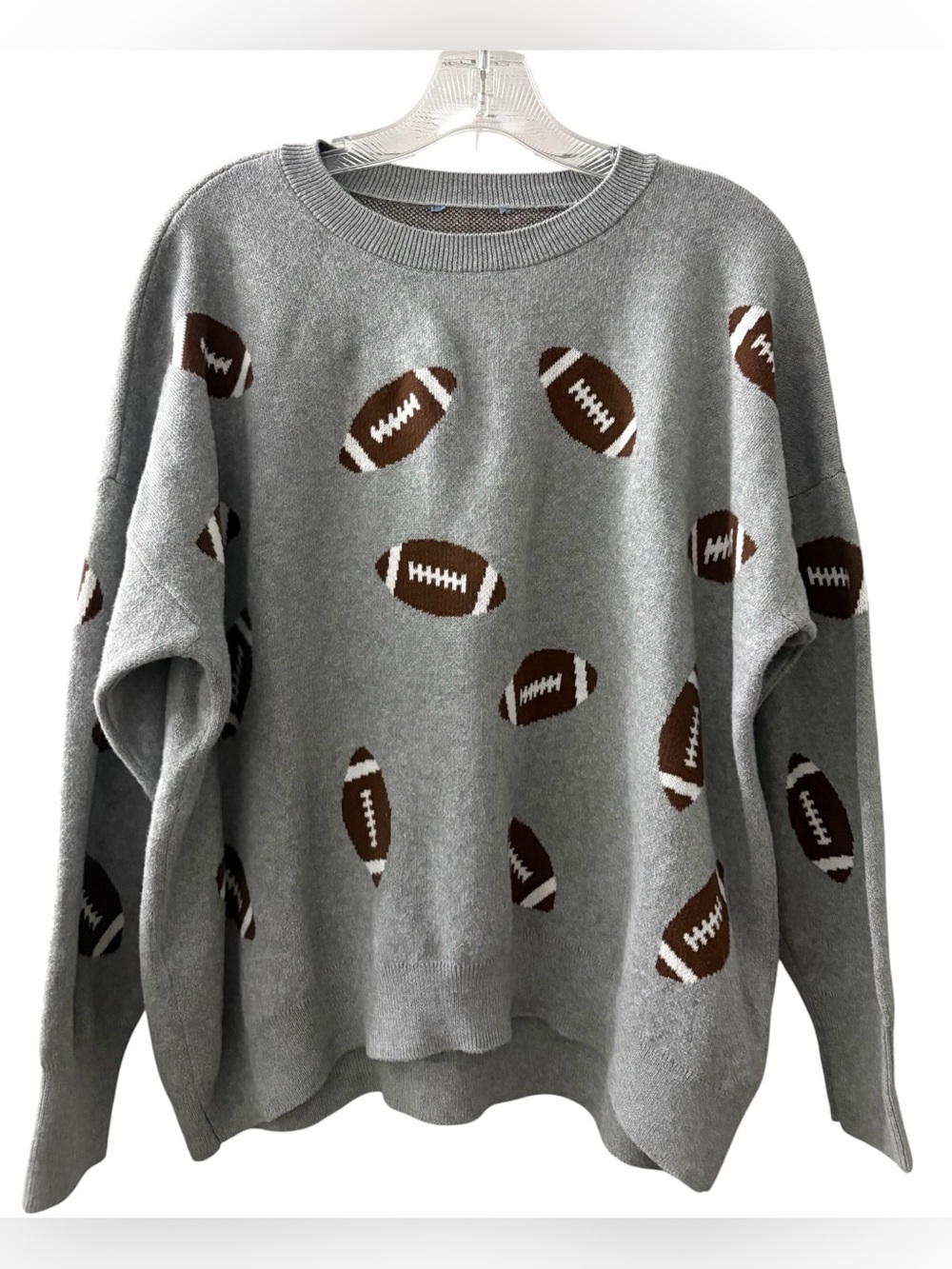 Fun Vince Camuto knit sweater featuring an all-over football pattern in brown an
